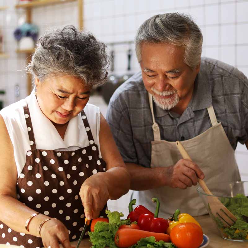 couple chopping vegetables