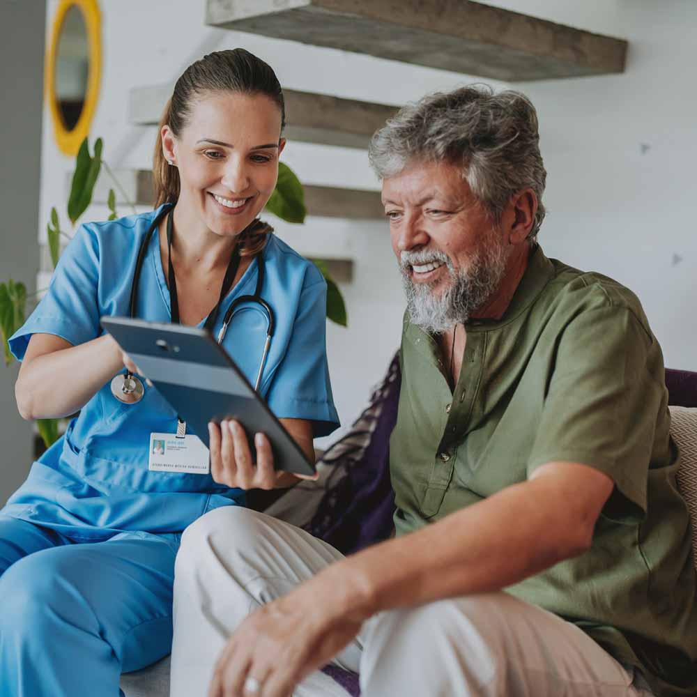 Clinician and patient looking at a tablet screen