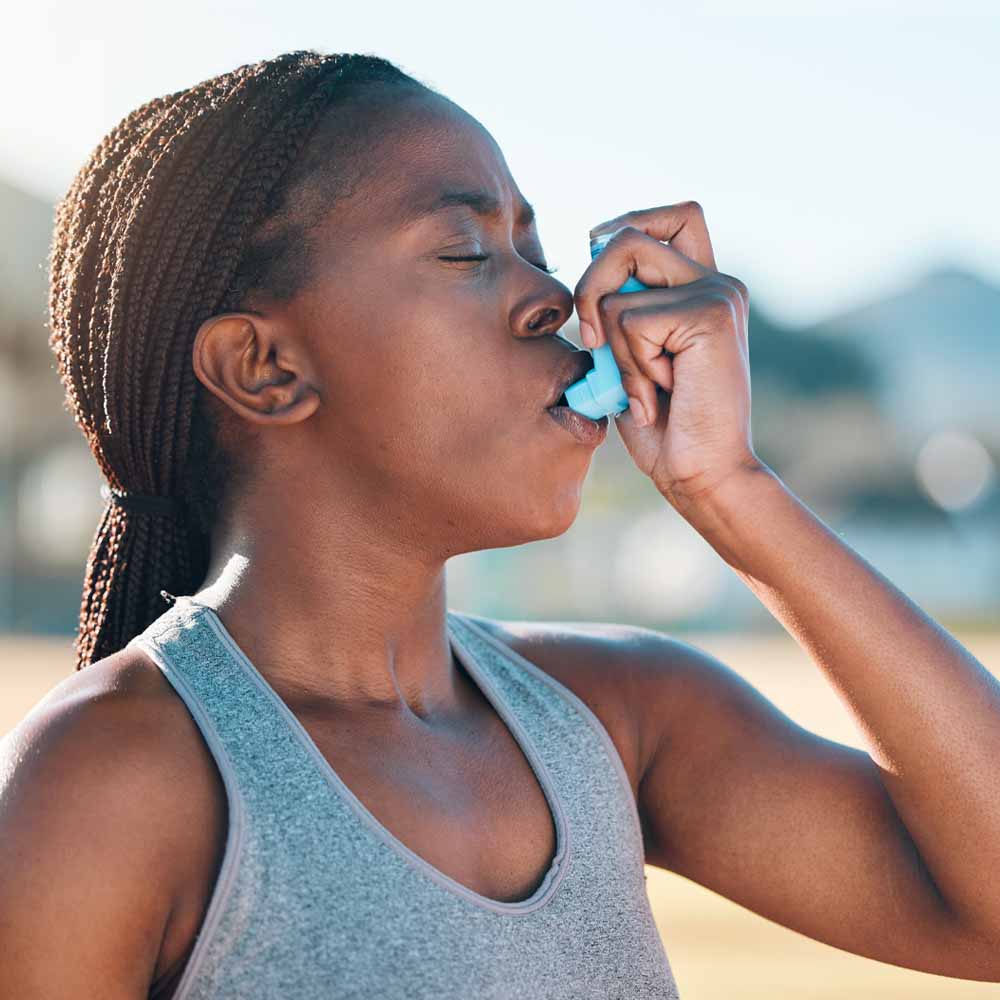 Woman using an inhaler