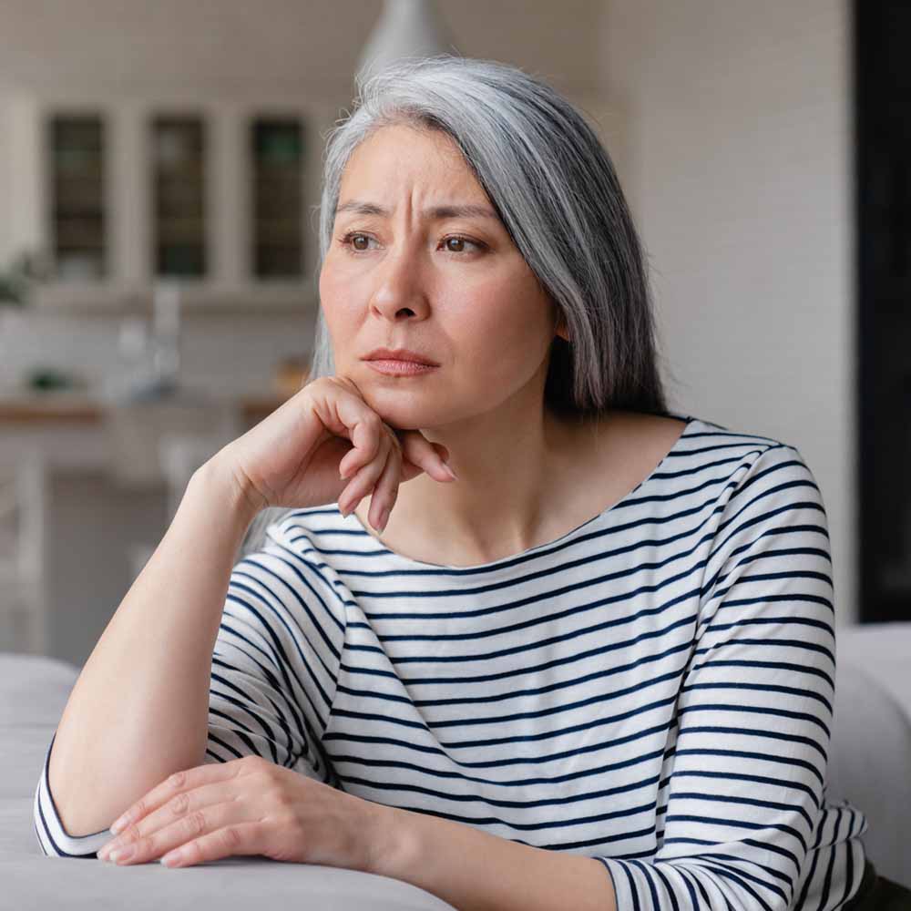 Lady in a striped top thinking