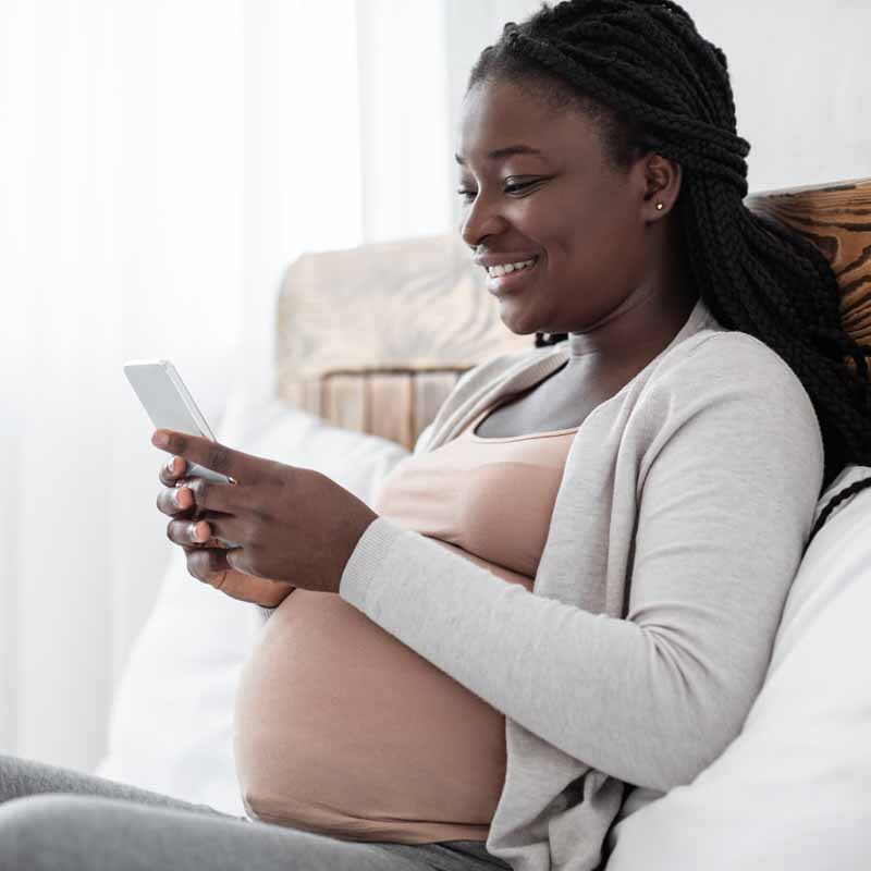 Pregnant woman using phone